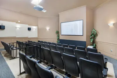 Resort clubhouse movie theater with a big screen and tiered seating, free for guests