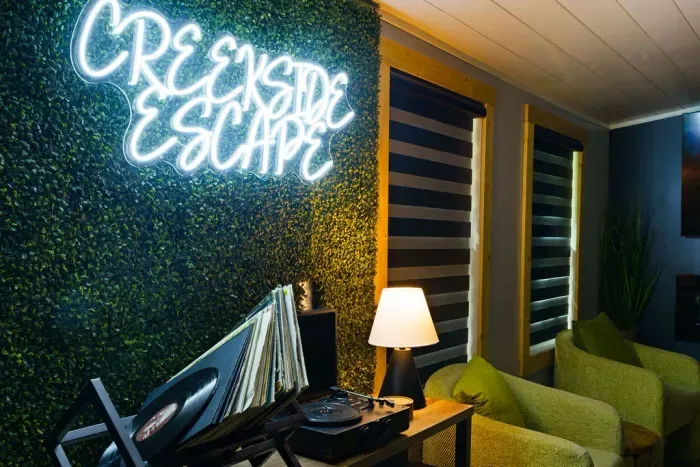 Cozy lounge with neon feature wall and vintage record player
