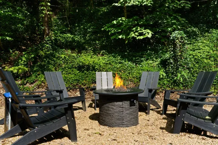 Private wooded fire pit lounge with Adirondack seating