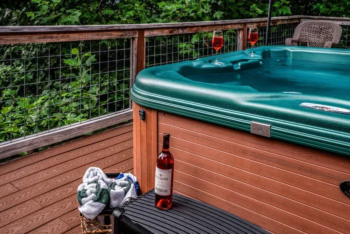 Private hot tub on a wooded deck for the ultimate relaxing escape