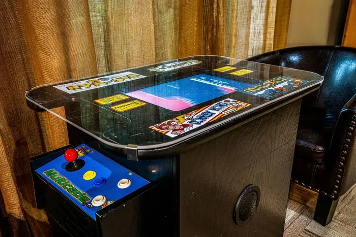 Retro arcade cocktail table for nostalgic gaming fun indoors