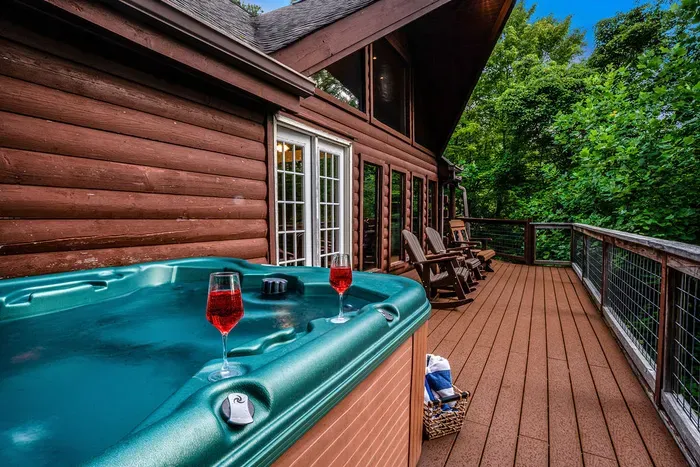 Private hot tub deck with rocking chairs and serene forest views