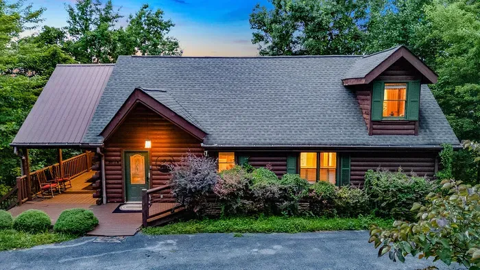 Cozy wooded log cabin with rocking-chair porch and warm evening glow