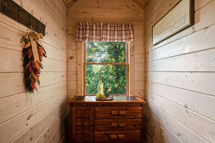 Charming cabin nook with rustic wood accents and peaceful leafy views