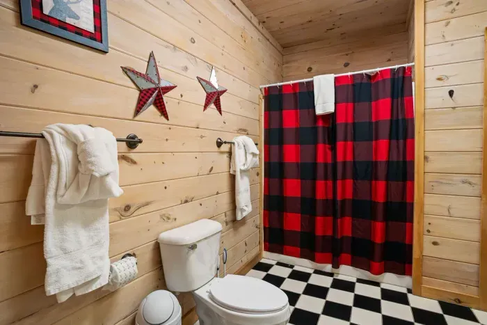Rustic cabin bathroom with buffalo plaid accents and cozy lodge charm