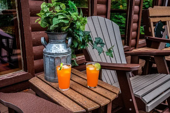 Relax on the rustic porch with Adirondack chairs and refreshing drinks