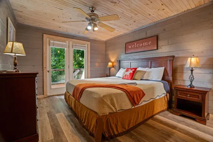 Cozy woodsy king bedroom with private outdoor access
