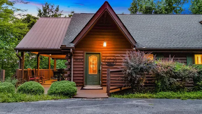 Cozy log cabin with rocking-chair porch in a peaceful wooded setting