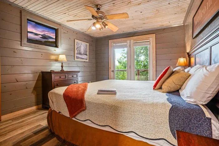 Cozy cabin bedroom with French doors and warm rustic charm