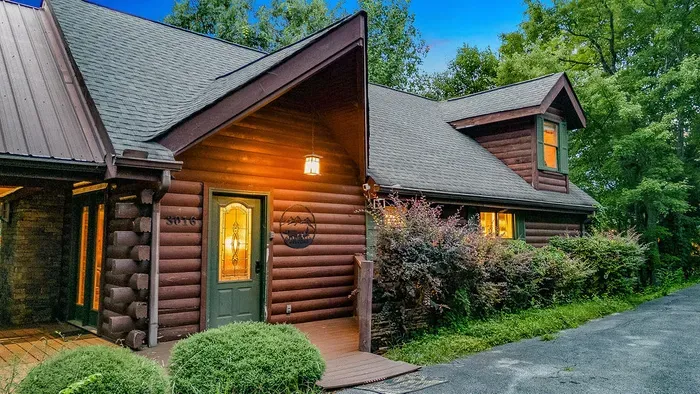 Cozy log cabin retreat with warm lights and wooded privacy