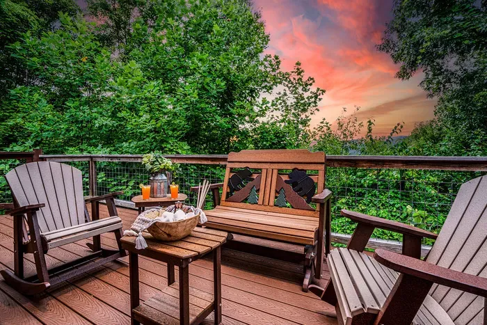Private woodland deck with cozy seating and stunning sunset views