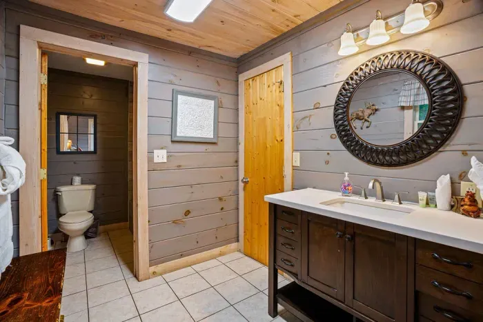 Rustic cabin bath with private water closet and spacious vanity