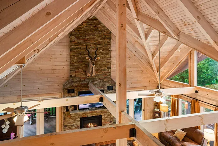 Soaring timber beams and a stunning stone fireplace in this cozy lodge retreat
