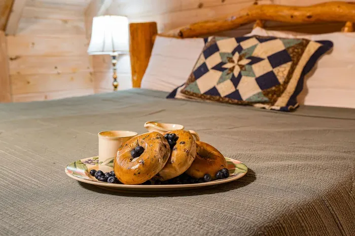 Cozy rustic bedroom with warm lighting and a charming breakfast touch
