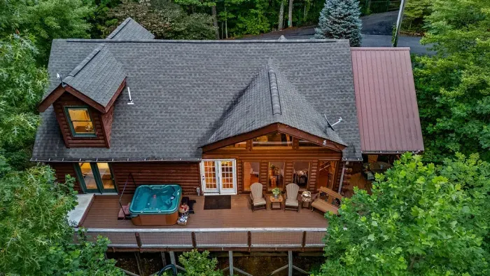 Private wooded cabin with spacious deck, hot tub, and cozy outdoor seating