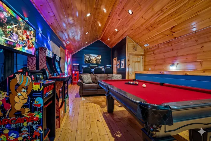 Cabin game loft: pool table, arcades, theater seating, neon vibes