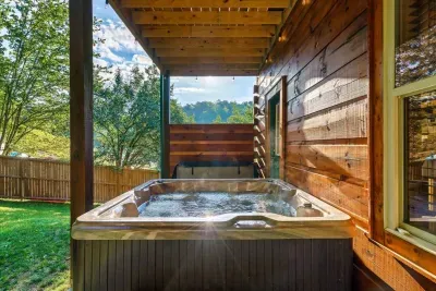 Outdoor covered hot tub with cafe lights and privacy