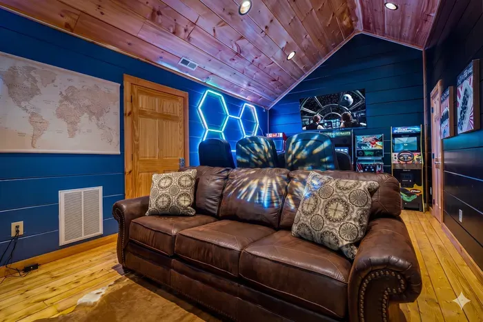 LED-lit game loft with leather sofa, arcades and racing simulators