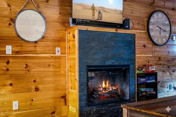 Cozy cabin hearth with TV and board games—perfect for nights in