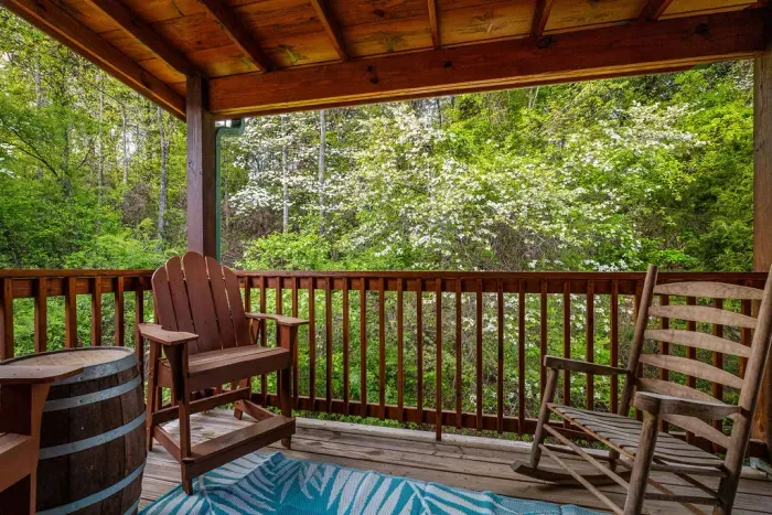 Covered deck with rocking chairs and tranquil forest views