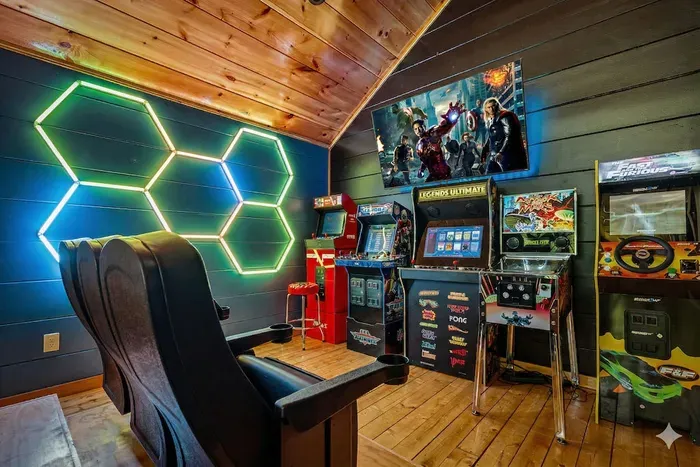 Arcade lounge with neon LED art, theater seats, and big-screen fun