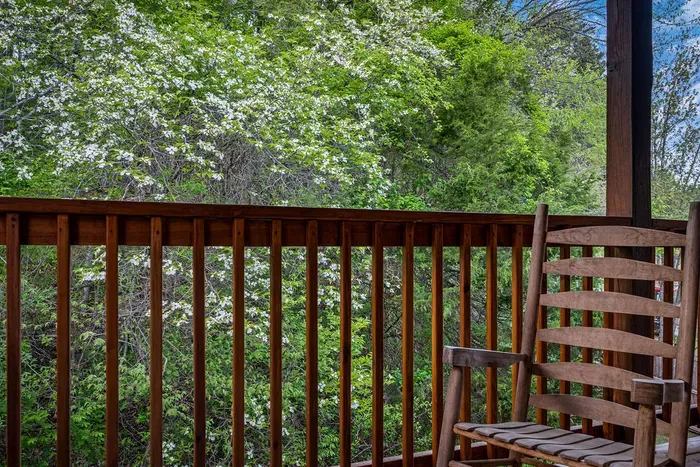 Private porch with rocking chair and tranquil, tree-filled views