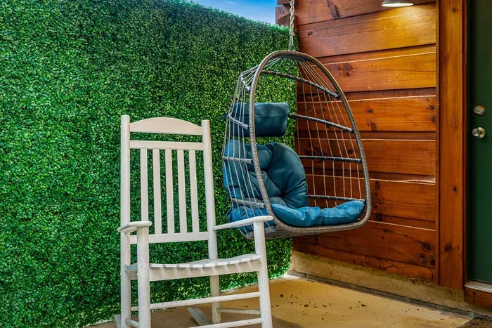 Cozy porch nook with rocking chair and cushioned swing seat