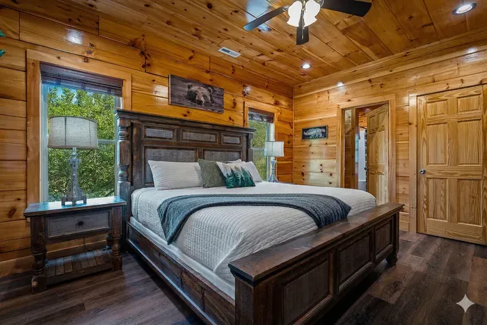 Cozy cabin king suite with wood interiors and ensuite bath.