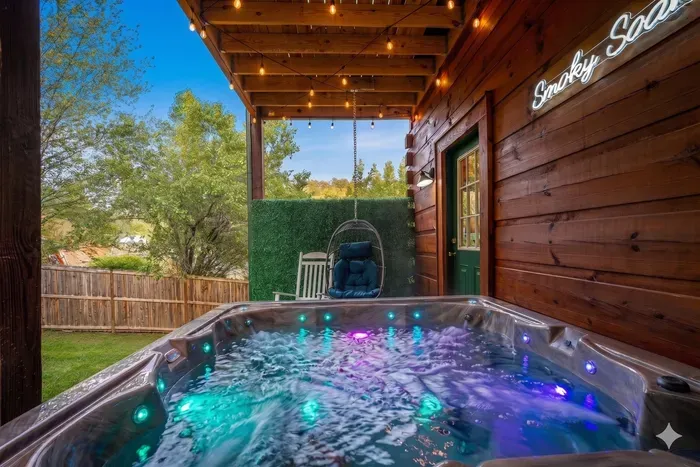 Private covered hot tub with LED lights, string lights & cozy seating
