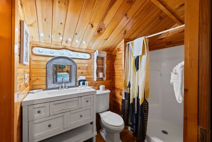 Loft bathroom with shower and walk in closet (not pictured)