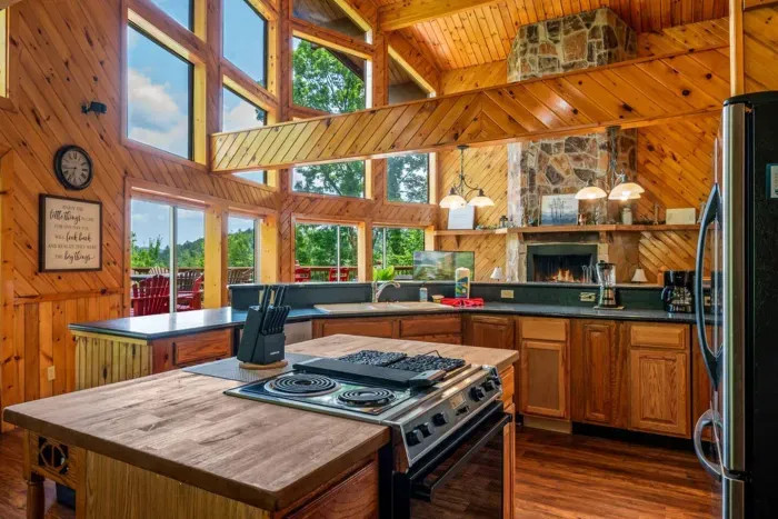 Full kitchen with two stoves, upgraded appliances and island with butcher block counter top 