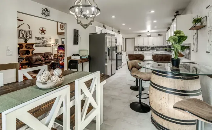 Bright rustic kitchen with barrel bar seating and open-concept layout