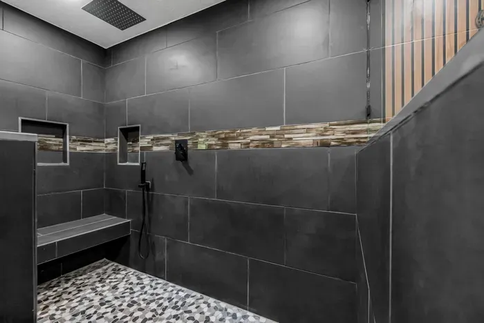 Spa-style walk-in shower with rainfall head and built-in bench