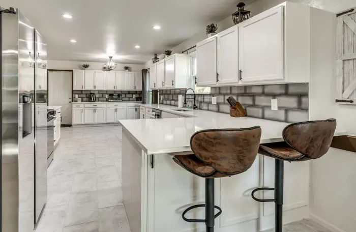 Bright modern kitchen with large island seating and stainless appliances