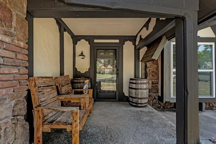Charming covered porch with rustic seating and cozy cabin-style details