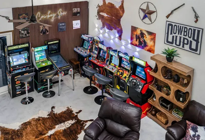 Western-themed arcade room with retro games and cozy lounge seating