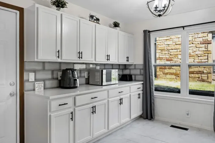 Bright modern kitchen nook with ample storage and natural light