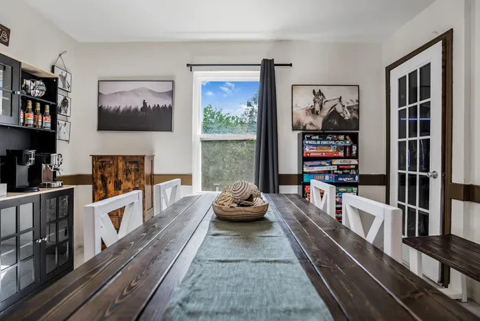 Rustic dining room with coffee bar, board games, and cozy farmhouse charm