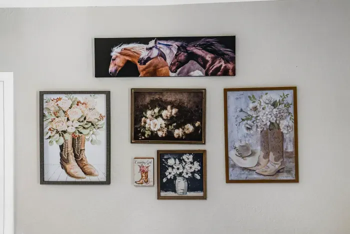 Rustic Western gallery wall with charming horse and floral artwork