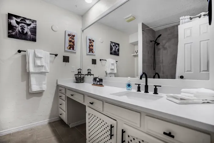 Spacious double-vanity bath with modern walk-in shower and stylish rustic accents