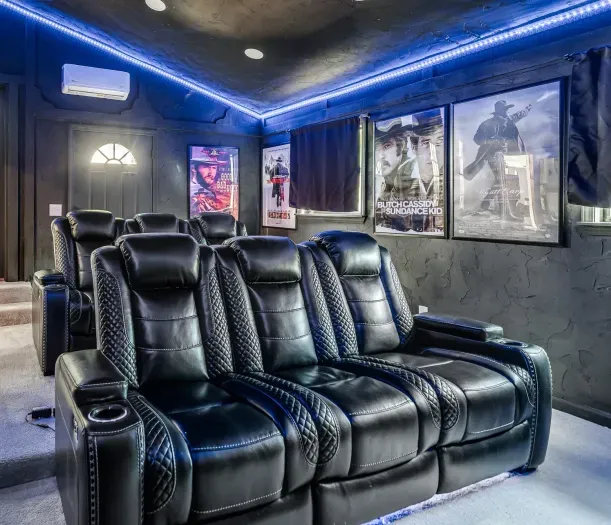 Private home theater with leather recliners and cinematic LED ambiance