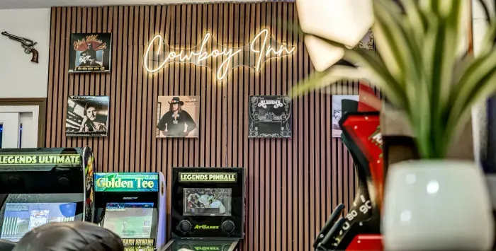 Western-themed game room with arcade machines and glowing neon style