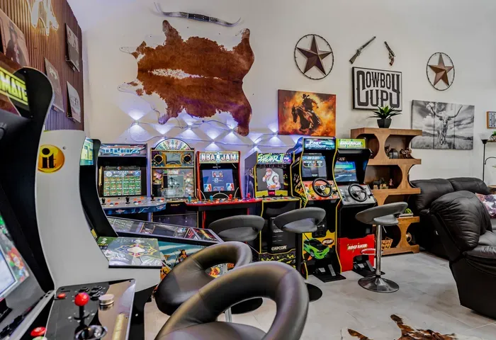 Epic arcade game room with retro cabinets, lounge seating, and Western flair