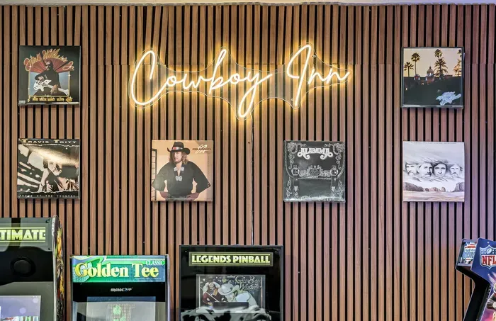 Music-themed arcade room with neon sign and retro gaming fun