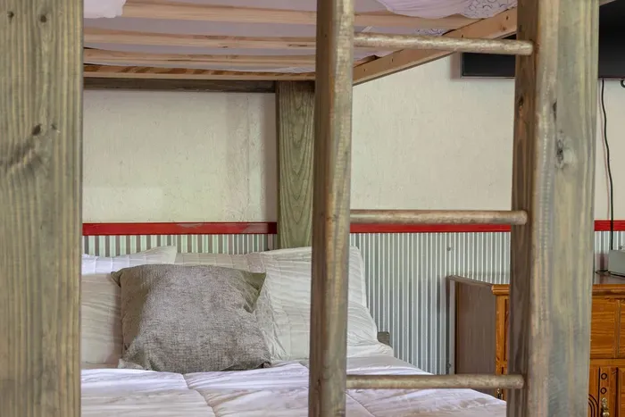 Cozy rustic bunk room with warm wood details and family-friendly sleeping space