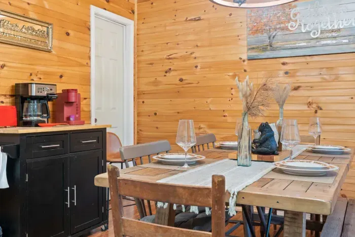 Cozy rustic dining space with farmhouse table and convenient coffee station