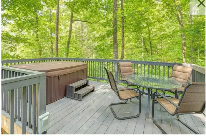 Secluded forest deck with hot tub and dining set—relax in nature