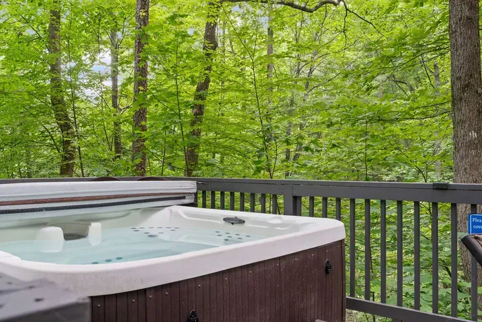 Private hot tub on a serene deck surrounded by lush forest views