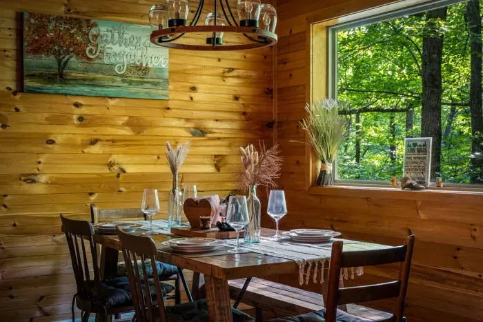 Rustic wood dining nook with forest views and cozy cabin charm