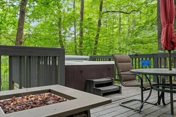 Private wooded deck with hot tub, fire pit, and peaceful forest views